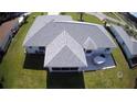 Aerial showing back of a gray roof home with screened in porch and patio at 10237 Sw 63Rd Ave, Ocala, FL 34476