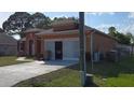 Exterior elevation of a charming home featuring a two-car garage and well-kept lawn at 1107 Dartford Dr, Kissimmee, FL 34758