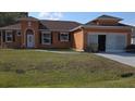 Inviting one-story home showcasing a neatly manicured front lawn at 1107 Dartford Dr, Kissimmee, FL 34758