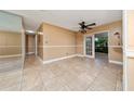 Bright dining room with tile flooring, neutral walls, ceiling fan and sliding doors to the patio at 1209 Marygon St, Kissimmee, FL 34744