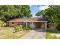 Charming single-story home with a covered carport, front landscaping, and inviting entryway at 1209 Marygon St, Kissimmee, FL 34744