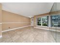 Bright living room with neutral walls, tile flooring, and large windows at 1209 Marygon St, Kissimmee, FL 34744