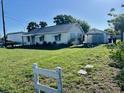 A single story house with a spacious yard and an adjacent garage, perfect for easy access parking at 1309 N Thacker Ave, Kissimmee, FL 34741