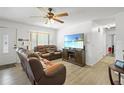 A bright living room with a large TV, comfortable furniture, and natural light from the window at 1408 Polk City Rd, Haines City, FL 33844