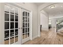 Inviting foyer featuring tile floors, and white framed french doors leading to a flex space at 152 Whirlaway Dr, Davenport, FL 33837