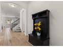 Hallway with tile flooring and an archway leading to the living room and stairs to the upper level at 152 Whirlaway Dr, Davenport, FL 33837