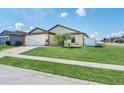 Traditional single-Gathering home offering a lush front lawn and ample street parking for convenient living at 1602 Steely Dr, Dundee, FL 33838