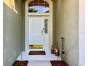 Inviting front door with decorative window above and a welcome mat and garden gnomes at 1784 Sparkling Water Cir, Ocoee, FL 34761