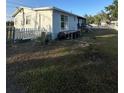 The backyard has a white picket fence with large yard at 1821 N Reedy Lake Blvd, Frostproof, FL 33843