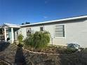 A side view of the house with a nice rock walkway at 1821 N Reedy Lake Blvd, Frostproof, FL 33843
