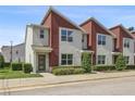Charming townhouse featuring a modern design, complemented by lush landscaping and a welcoming facade at 185 E Warren Ave, Longwood, FL 32750