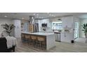 Modern kitchen featuring stainless steel appliances, a large island with bar seating, and ample white cabinetry at 2074 Dunsford Dr, Orlando, FL 32808