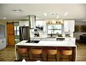 Modern kitchen featuring a spacious island, stainless steel appliances, and white cabinetry at 2074 Dunsford Dr, Orlando, FL 32808
