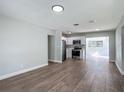 Bright living room with new hardwood floors, leading into a kitchen at 220 Hillside Dr, Lakeland, FL 33803