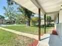 Inviting front porch with wooden supports and a view of the green front yard at 220 Hillside Dr, Lakeland, FL 33803