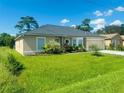 Single-story home with a neat lawn, lovely landscaping and a two-car garage at 236 Rontunda Dr, Kissimmee, FL 34758