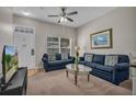 Cozy living room with comfortable seating, ceiling fan, and bright natural light at 2614 Lodi Cir # 106, Kissimmee, FL 34746
