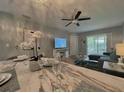 Dining area leading into a living area, featuring wood floors, and bright natural light at 2798 Club Cortile Cir # A, Kissimmee, FL 34746