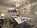 Dining room with a table, chandelier, hard wood floors, seating for four, and decorative wall art at 2798 Club Cortile Cir # A, Kissimmee, FL 34746