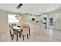 Dining area featuring modern light fixture and table with views into the kitchen at 3134 Koval Ct, Orlando, FL 32837