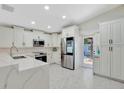 Bright kitchen with stainless steel appliances, white cabinets, and an adjacent door to the backyard at 3134 Koval Ct, Orlando, FL 32837