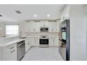 Modern kitchen featuring stainless steel appliances, white cabinetry, and quartz countertops at 3134 Koval Ct, Orlando, FL 32837