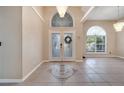 Inviting foyer with decorative tile, high ceilings, and elegant chandeliers create a grand entrance at 3211 Countryside View Dr, St Cloud, FL 34772
