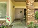 Welcoming front entry features double doors, brick columns, and decorative plants at 42 Chip Ct, Kissimmee, FL 34759