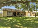 Charming single-story home with a brick-accented entrance and lush green lawn at 42 Chip Ct, Kissimmee, FL 34759