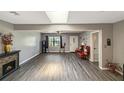 Bright living room featuring wood floors, a decorative fireplace, and skylight at 4218 Drexel Ave, Orlando, FL 32808