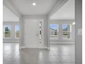 Bright foyer with neutral gray tile flooring, and lots of natural light at 555 Viceroy Ct, Kissimmee, FL 34758