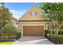 Charming home featuring a two-car garage, neat landscaping, and a brick driveway at 781 Golden Bear Dr, Kissimmee, FL 34747
