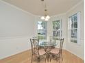 Cozy dining room with bay window, white wainscotting, and a charming chandelier at 847 Orista Dr, Davenport, FL 33897