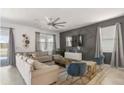 Bright and airy living room with modern furnishings and decorative wall art at 9118 Sommerset Hills Dr, Davenport, FL 33896