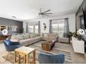 Spacious living room with a large sectional sofa, stylish decor, and ample natural light at 9118 Sommerset Hills Dr, Davenport, FL 33896