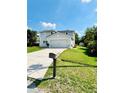 Charming two-story home with a well-manicured lawn and a two-car garage, located on a sunny street at 467 Martigues Drive, Kissimmee, FL 34759