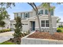 Inviting two-story home with stone accents, lush landscaping, and a two-car garage offering classic curb appeal at 1051 Cloud Ridge Ct, Mount Dora, FL 32757