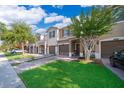 Charming townhouses with a brick driveway, lush green lawn, and well-maintained landscaping at 10733 Savannah Landing Cir, Orlando, FL 32832