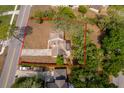 An aerial view displays a nice home with a long driveway and mature trees surrounding the property at 120 W Minnehaha Ave Ave, Clermont, FL 34711