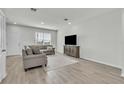 Comfortable living room features neutral tones, modern furniture, and wood-look flooring at 12190 Plumpton Dr, Winter Garden, FL 34787