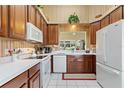 Well-lit kitchen features ample cabinet space, white appliances, and a large window at 124 Ashton Dr, Davenport, FL 33837