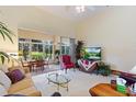 Bright living room with high ceilings, neutral carpet, and large windows showcasing outdoor views at 124 Ashton Dr, Davenport, FL 33837
