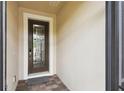 An elegant front door with decorative glass welcomes you, set against a neutral exterior with brick pavers at 1272 Bonita Canyon Dr, Poinciana, FL 34759
