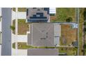 Birds-eye view showcasing the property's roof, driveway, and a spacious backyard, nestled in a residential neighborhood at 1490 Olive Ct, St Cloud, FL 34771