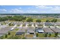 Community aerial view highlighting the neighborhood's layout, with tidy backyards and proximity to green spaces and ponds at 1490 Olive Ct, St Cloud, FL 34771