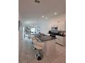 Modern kitchen features a granite countertop island with bar seating and stainless steel appliances at 2034 Old Pasture Ln, Lakeland, FL 33801