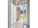 Bright entryway showcasing wood flooring and a welcoming view of the home's exterior at 265 Curtis Ave, Groveland, FL 34736