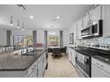 Well-equipped kitchen with granite countertops, stainless steel appliances, and a breakfast bar overlooking the living area at 2715 Barclay Ln, Kissimmee, FL 34743