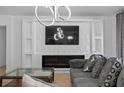 Stylish living room featuring a modern fireplace, decorative wall panel, and comfortable seating area at 2715 Barclay Ln, Kissimmee, FL 34743