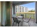 Balcony with a table and four chairs overlooking the exterior of the community at 3150 Paradox Cir # 104, Kissimmee, FL 34746